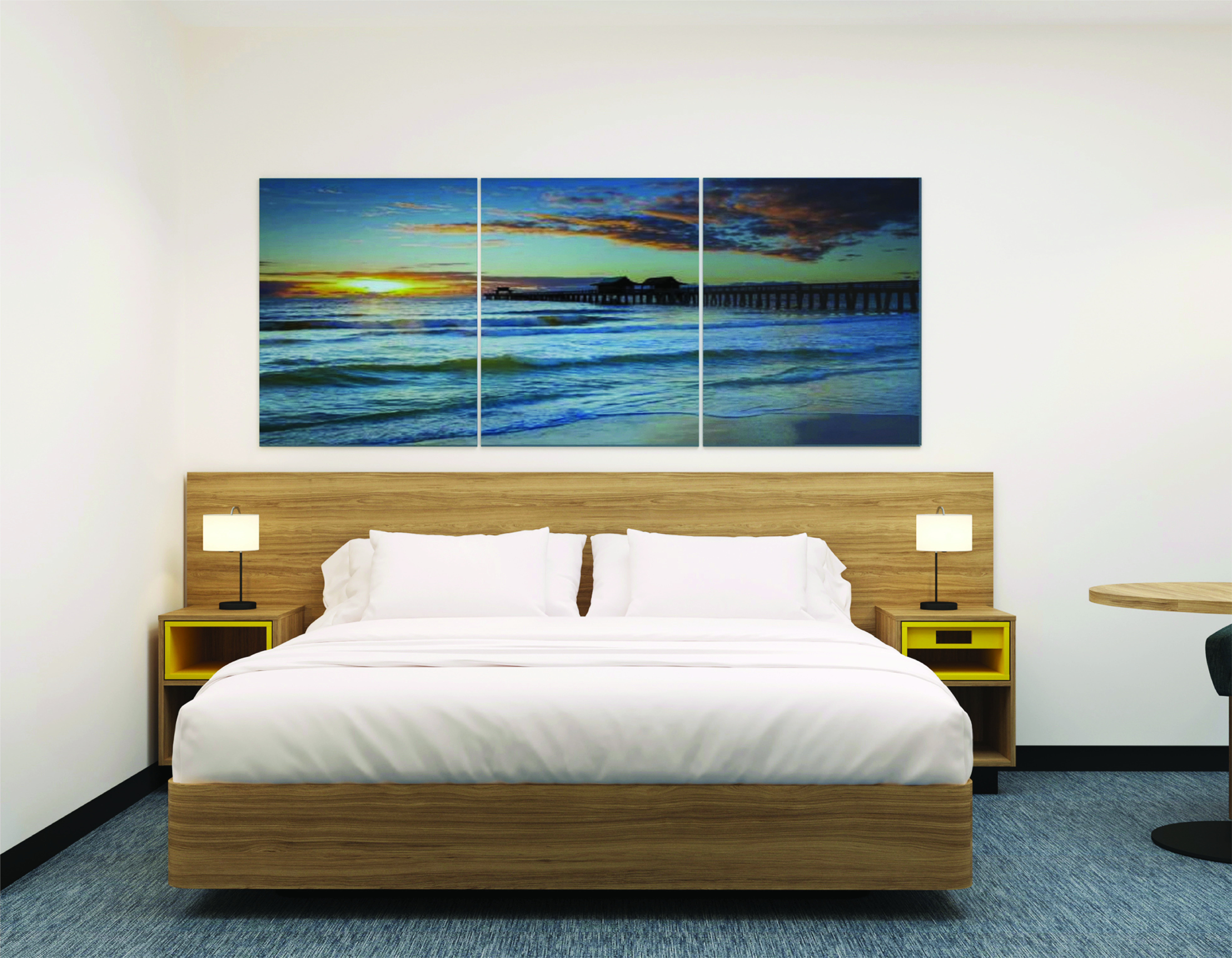Guest room with king bed and triptych sunset pier wall art