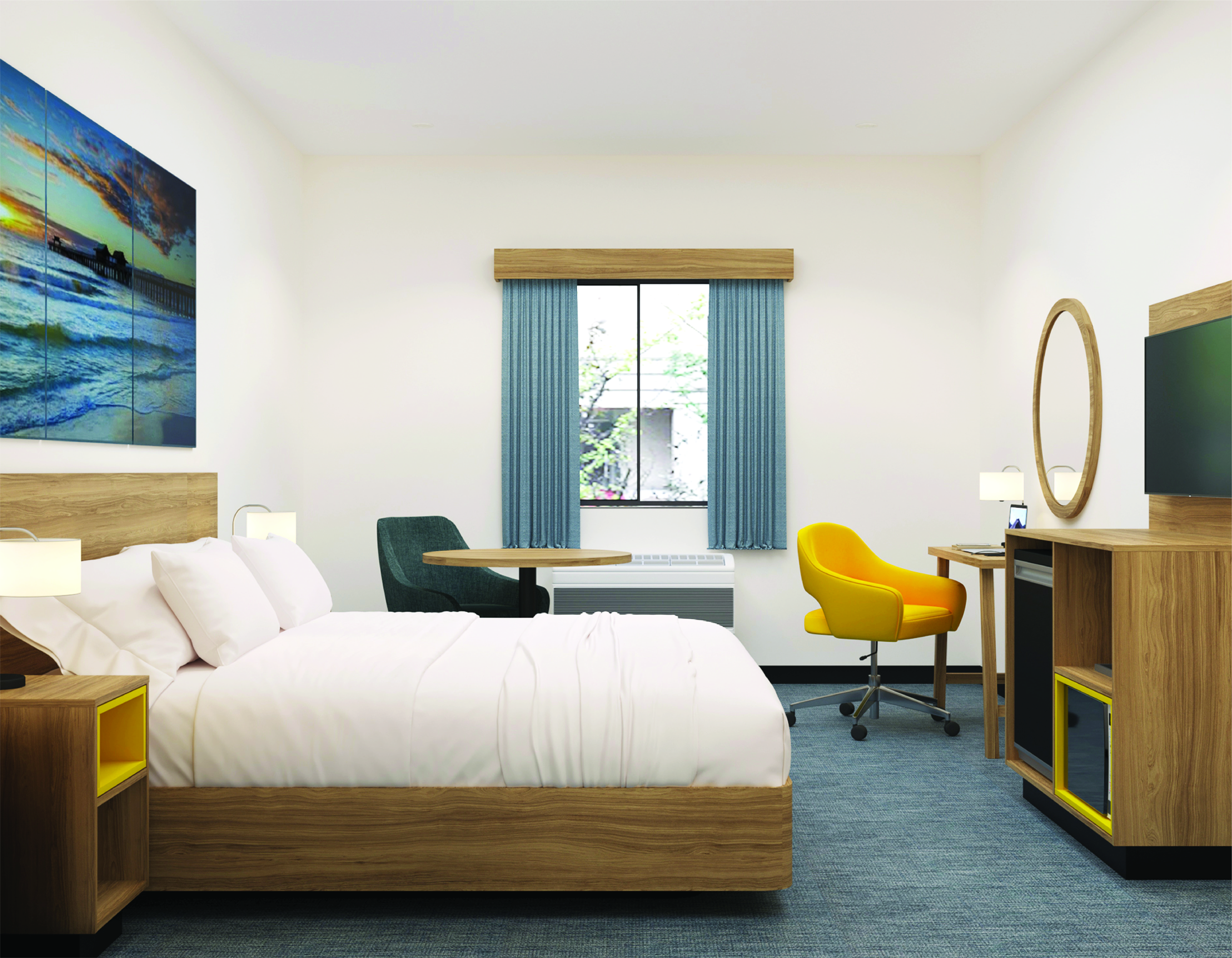 Guest room with lounge chair, round coffee table and desk area