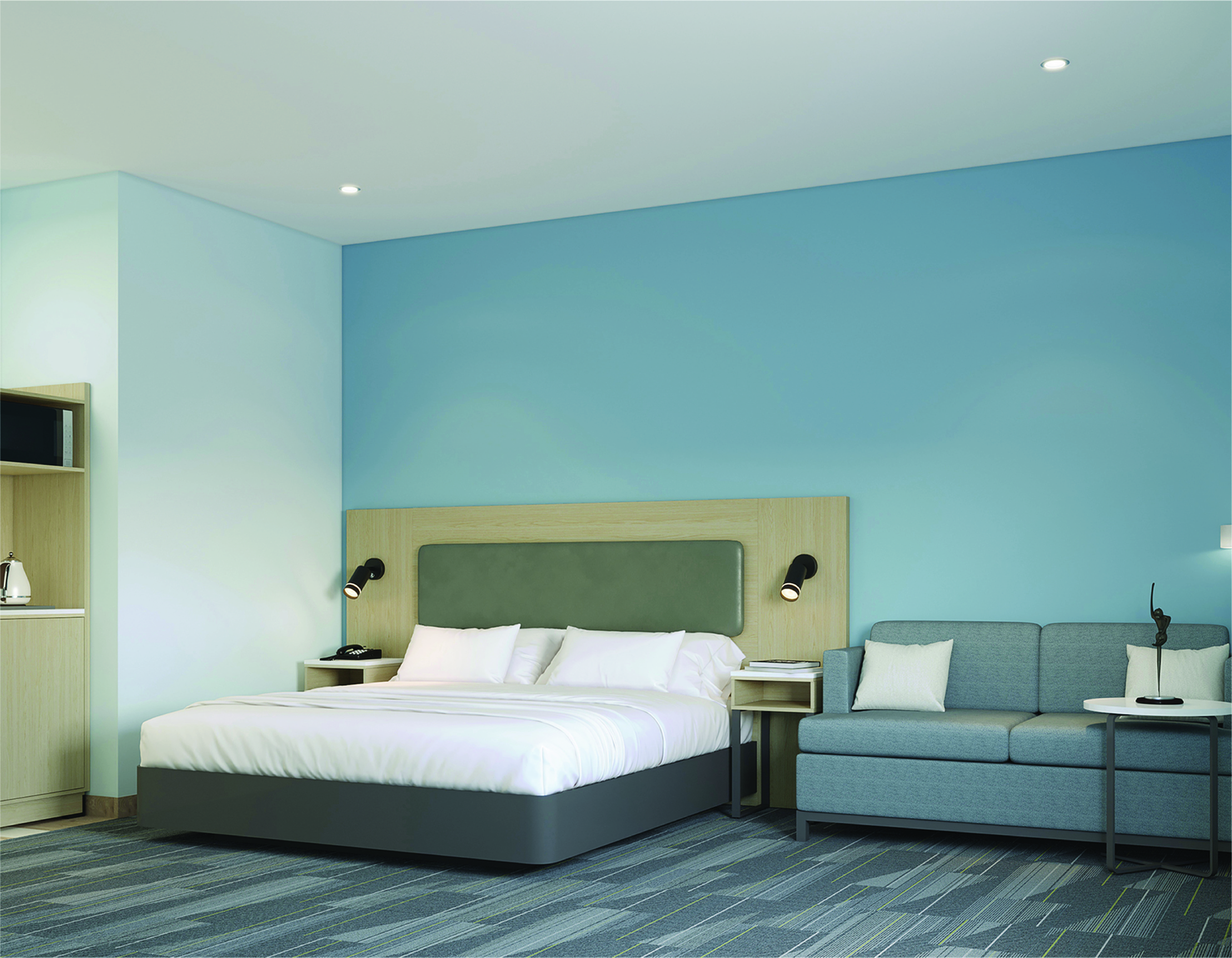 Guest room with king bed, sleeper sofa and teal accent wall