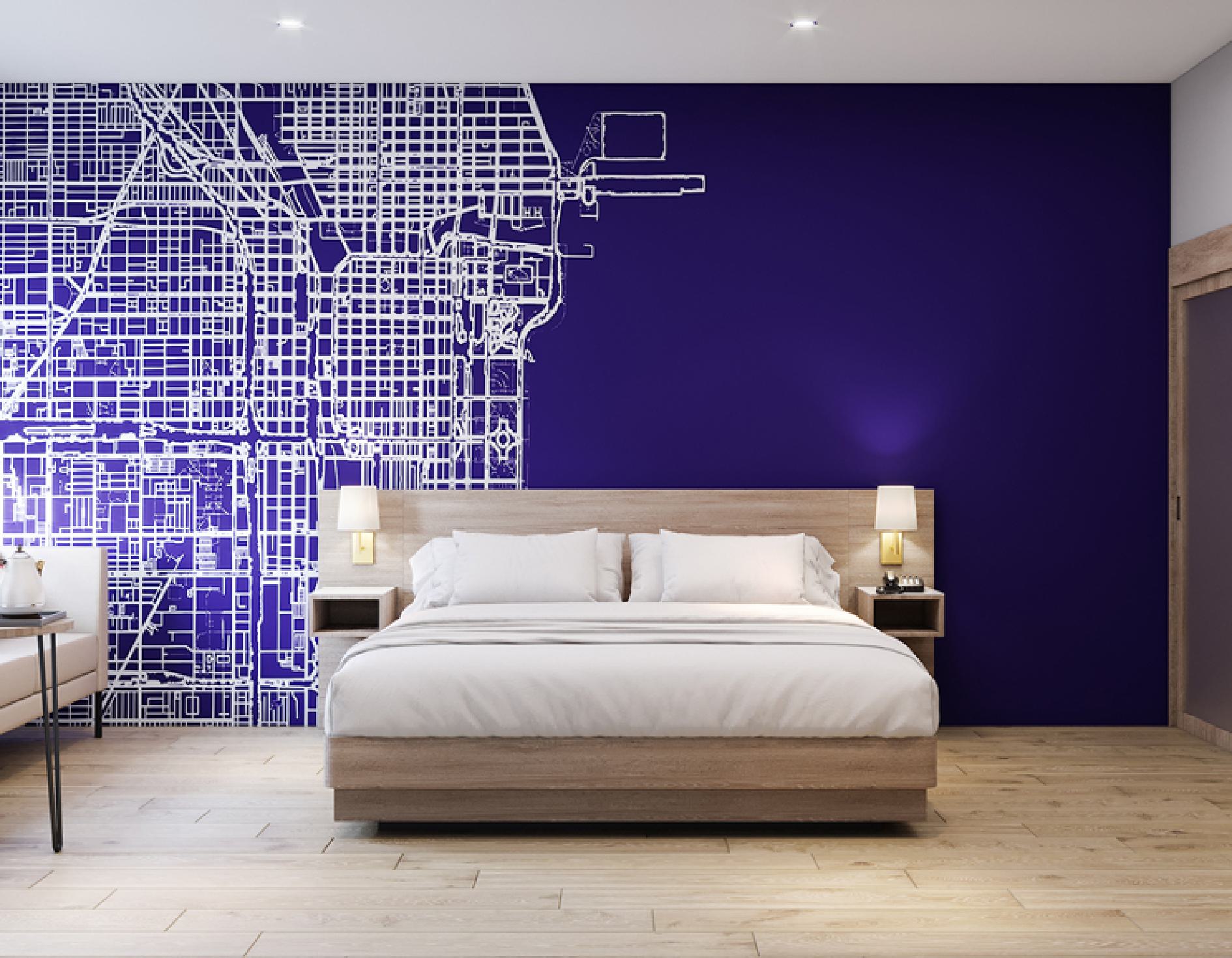 Guest room king bed with city map accent wall and wood headboard